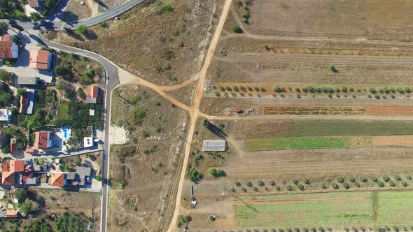 Aerial view of paved road intersecting with dirt road alt
