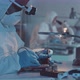Engineer in Protective Coveralls Soldering Motherboard in Lab - VideoHive Item for Sale