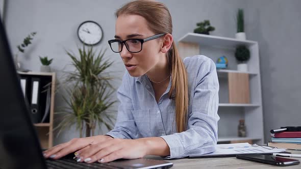 Blond Girl in Glasses Looking at the Computer Screen and Smiling From Seen Result alt