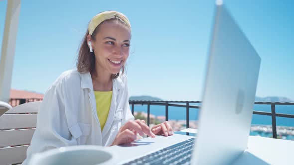 Pleased Woman Enjoying Morning Coffee While Sitting on Terrace with Sea View on Turkish Resort Using alt