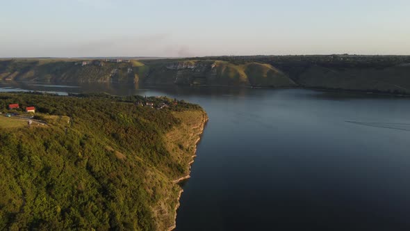 Aerial view of wide Dnister river and distant rocky hills in Bakota area, part of the National park,