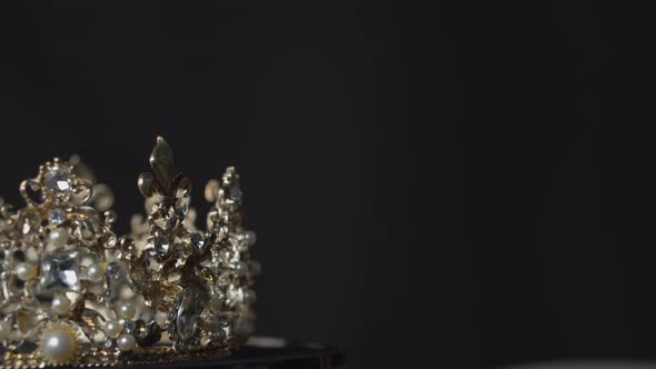 Amazing valuable crown for a royal queen, bride or beauty pageant winner on display on a turntable s alt