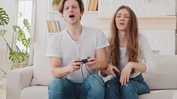Married Couple Caucasian Woman and Millennial Man Boyfriend and Girlfriend Playing Console Online alt