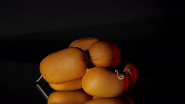 Delicious Raw Sausages Lie on Black Glass Table Rotating alt