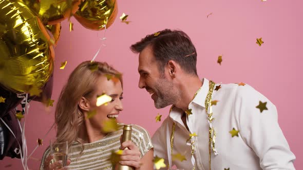 Loved couple dancing with champagne and balloons. Shot with RED helium camera in 8K alt