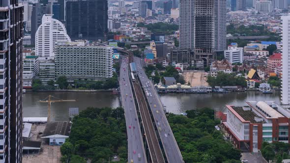 Bangkok traffic on Taksin bridge over Chao Phraya river during rush hour in  morning - time lapse