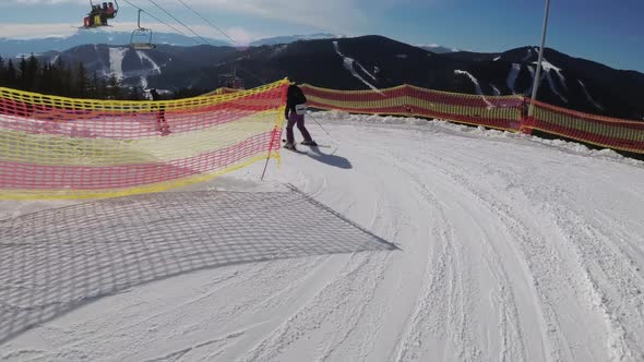 First-person View Skiers and Snowboarders Slide Down on Ski Slope at Ski Resort alt
