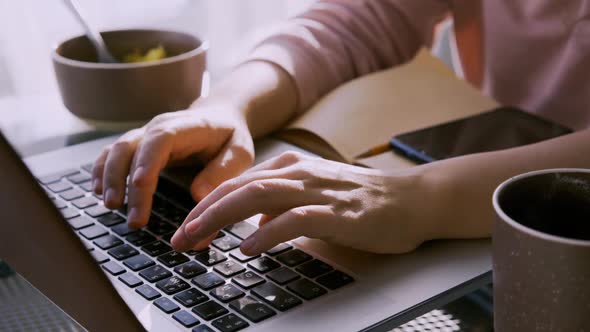 Woman Eat Cereals From Bowl and Working on Laptop