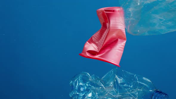 Plastic Trash in Ocean Water Sea Pollution Caps and Glasses Ecology Problems Waste and Garbage alt