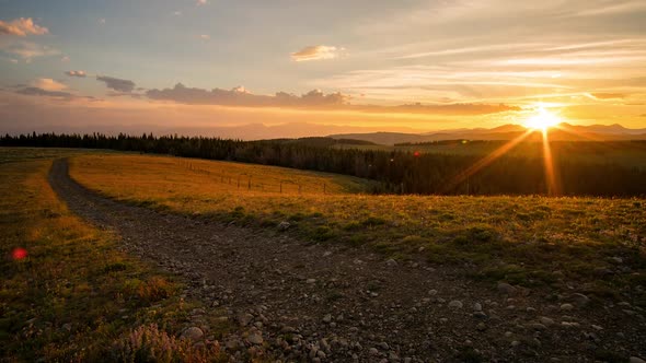 Sunset time lapse viewing dirt road through the Idaho landscape alt
