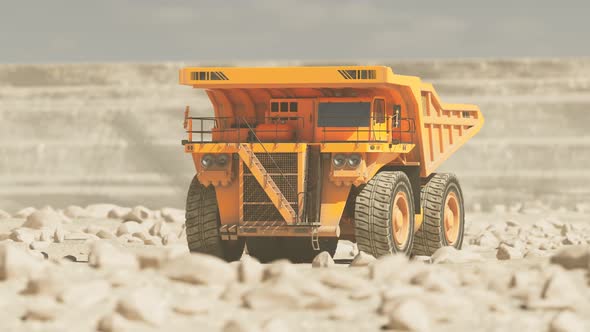 Big dump truck driving through the middle of a vast sand quarry far away. 4KHD alt