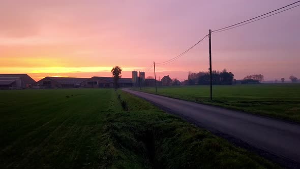 Aerial Cinematic Clip Drone Flying Over a Farm Field During Sunset alt