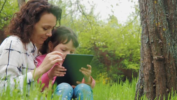Family in Nature with a Tablet alt