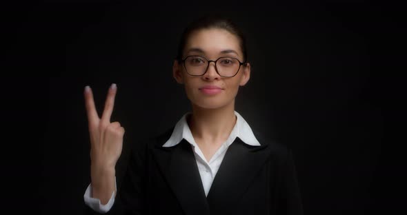 Business Woman with Glasses with a Serious Face Shows Two Finger