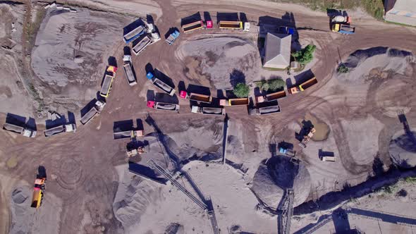 Excavator Loading Crushed Stone Into a Dump Truck in a Crushed Stone Quarry alt