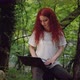 Woman is Using a Computer in an Forest - VideoHive Item for Sale