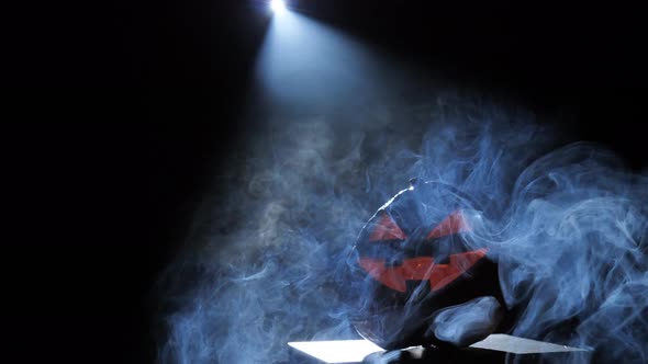 Halloween Pumpkin Smile and Scary Eyes for a Party Surrounded By Smoke alt