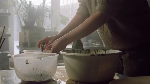 Woman Is Pouring Glaze Into Bowl