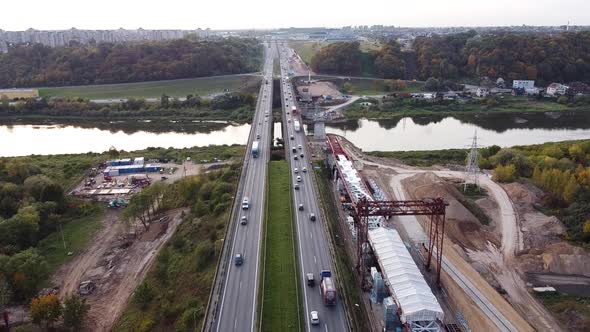 The A1 highway bridge over river Neris in Kaunas, Lithuania in drone aerial static shot. Heavy traff alt
