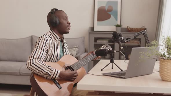 Young African Man Playing Guitar alt