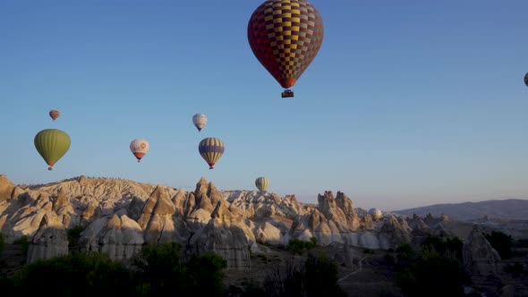 Cappadocia, Turkey: Drone shot of many hot air balloon flying over idyllic Love Valley alt