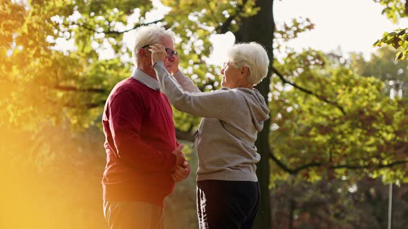 Elderly Caucasian Woman Putting Glasses on Her Husband People Suffering From Bad Eyesight Support alt