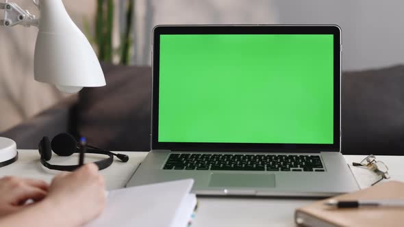 Unrecognizable Girl Looking at Green Screen Chroma Key Laptop Computer in Living Room Watching Movie alt