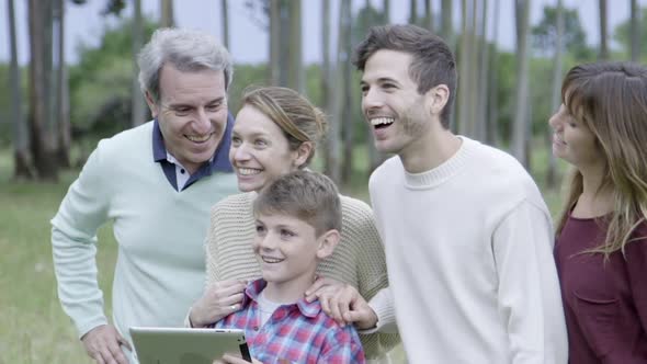 Family together outdoors, looking in awe at something out of frame alt