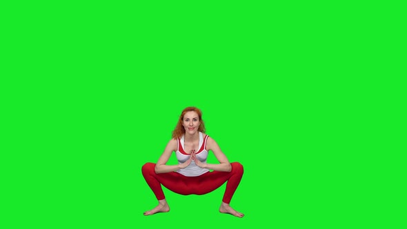 Sporty Woman Doing Yoga Exercises Against Green Screen Background