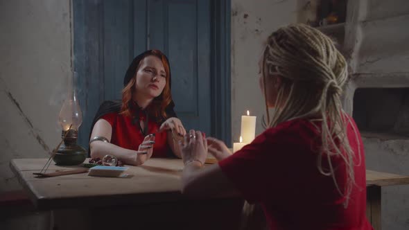 Grateful Female Client Paying for Divination Indoor alt