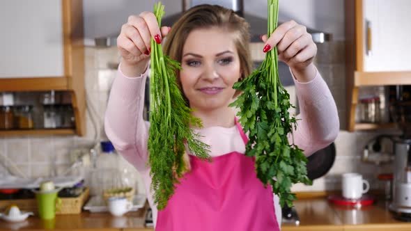 Woman Shows Dill and Parsley 