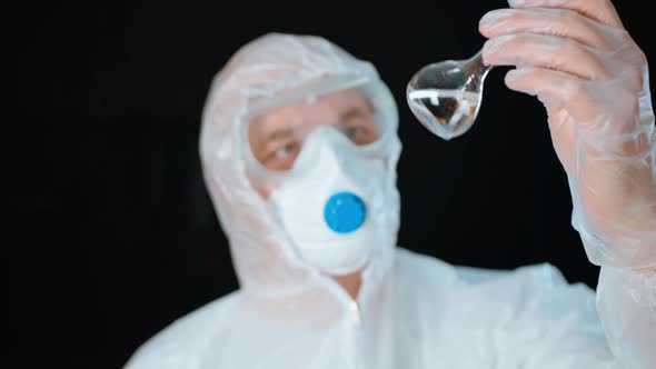 Bioengineer Looking at Test Tube with Colorless Liquid Isolated on White Background. Medical Worker alt