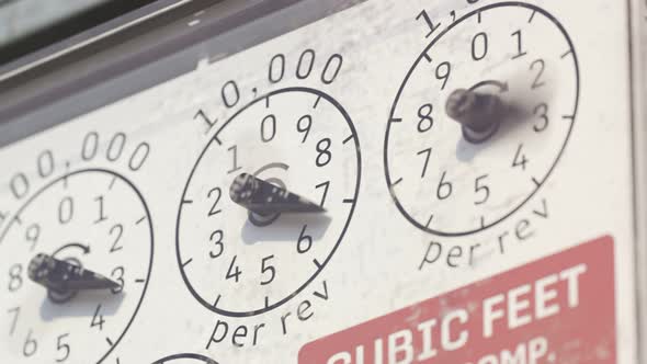 A gas meter gauges in closeup camera. Fast fuel flow shown in a timelapse. 4KHD