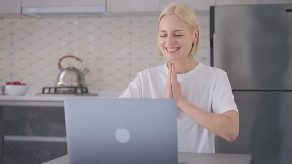 Young Blonde Woman Finishes Online Purchase and Claps Happily