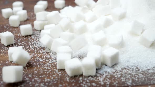 Sugar and Refined Sugar on Wooden Background