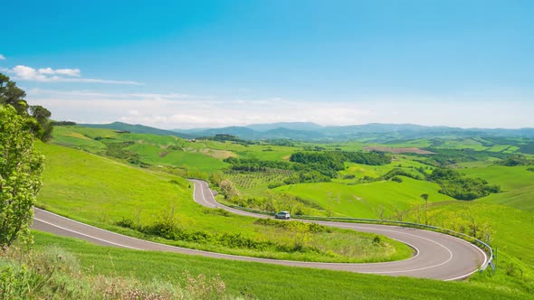 Time lapse: unique green landscape in Volterra region, Tuscany, Italy. Scenic clouds moving by wind alt
