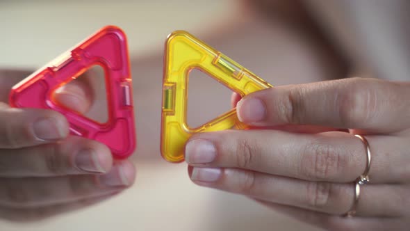 Close Up of Magnetic Building Toy. WOman Playing with Preschooler.  alt