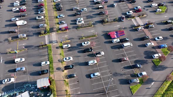 Aerial View of Many Colorful Cars Parked on Parking Lot with Lines and Markings for Parking Places alt