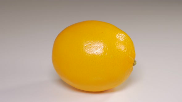 Lemon on white reflective background  dolly 4K 2160p UHD video - Yellow fresh lemon  on reflective s alt
