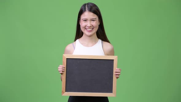 Young Beautiful Asian Businesswoman Holding Blackboard