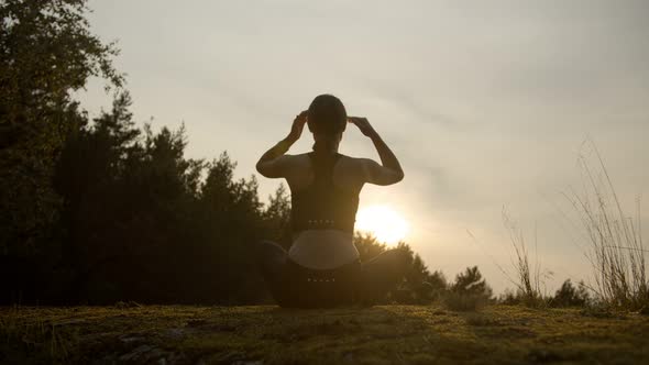 Girl Meditates on the Horizon with Sunset