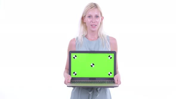 Happy Young Beautiful Blonde Woman Talking While Showing Laptop alt