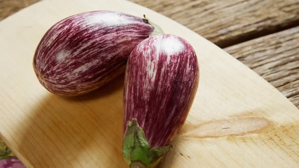 Two eggplant on chopping board 4k alt