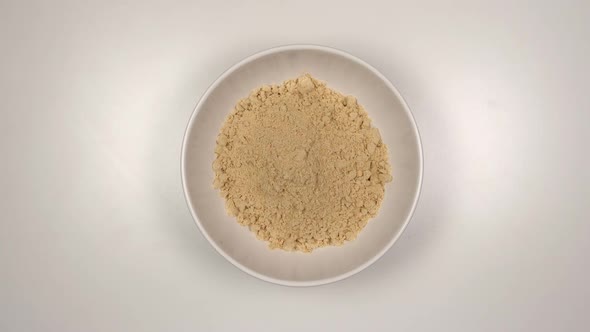 Ginger powder fill a white dish