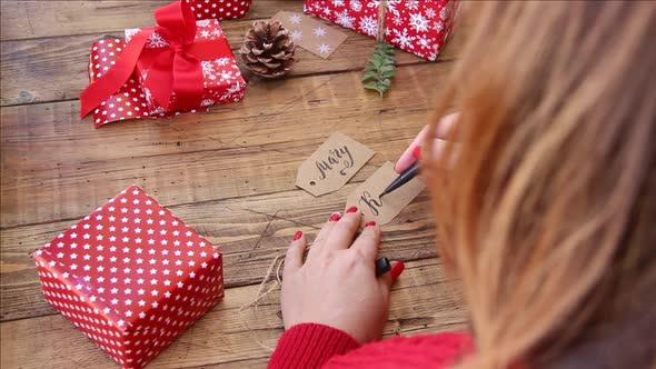 Writing name on gift tag for Christmas present alt