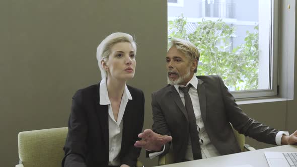 Business people discussing in office alt