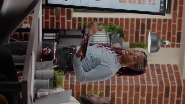 Vertical Video Multi Ethnic Colleagues Presenting Analysis Charts on Display alt