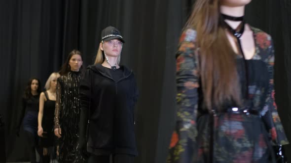 Several Female Models Walking in Row on Fashionable Luxury Vogue Show Runway alt
