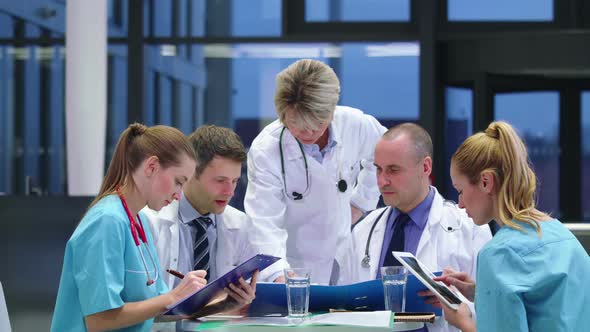Team of doctors having a meeting in conference room alt