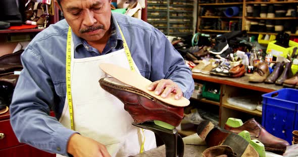 Cobbler working on shoe sole alt